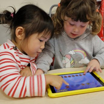 Girls playing bugs and bees number app
