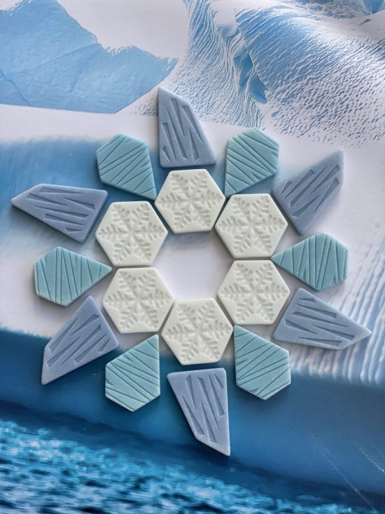 A collection of polar-inspired play stones (iceberg, ice sheet and snowflakes) made from a durable stone mix
