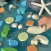 A collection of ocean-inspired play stones (wave, shell and coral) made from a durable stone mix