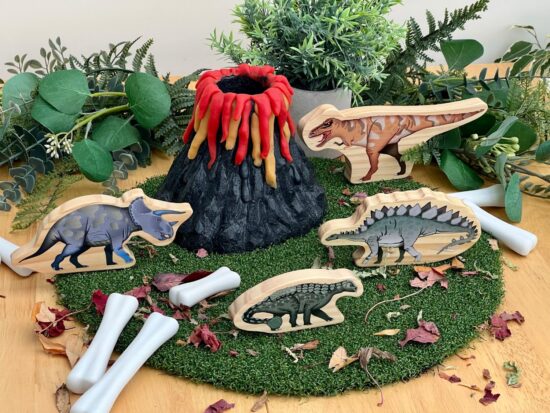 stone play volcano with wooden dinosaurs