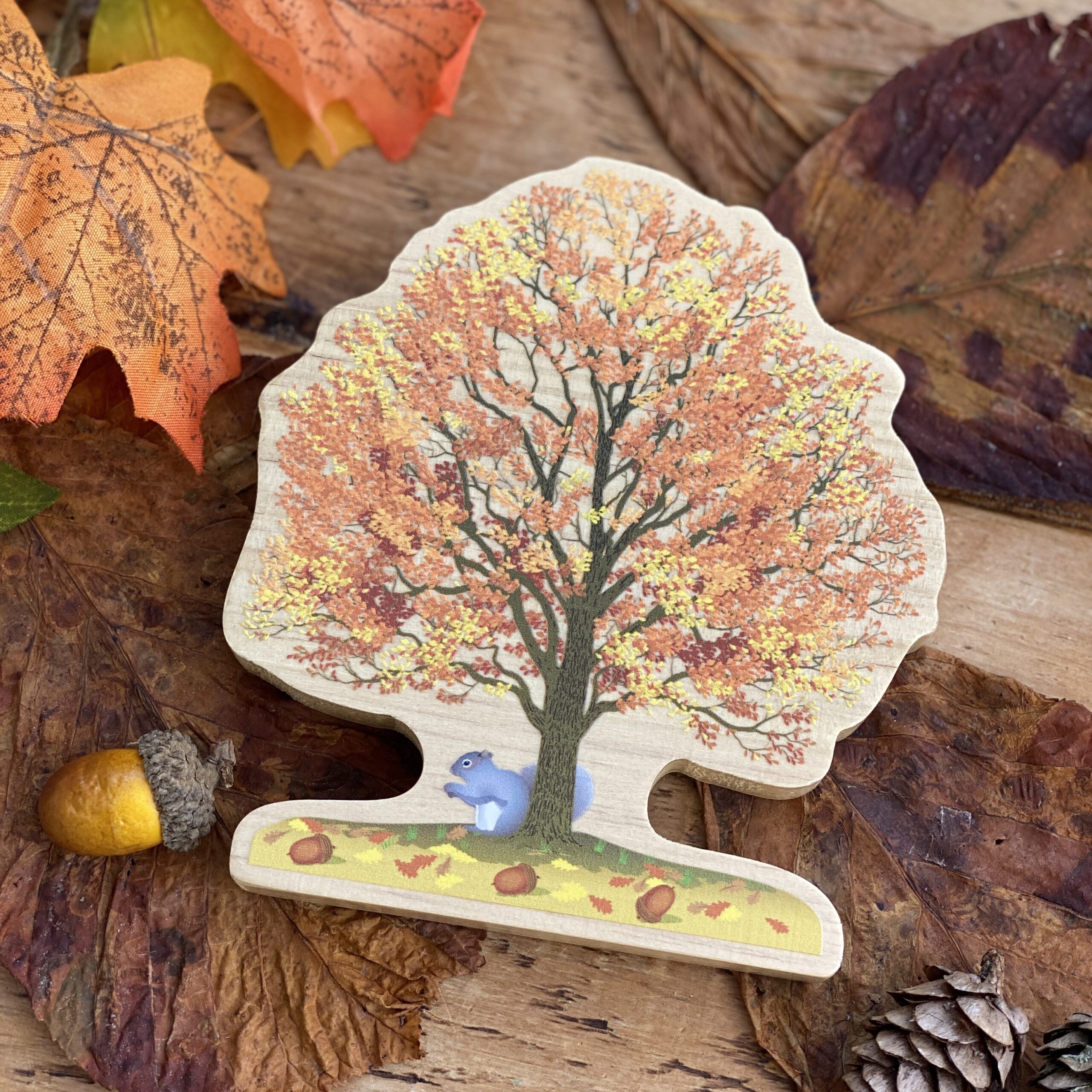 autumn wooden tree with squirrel and acorn