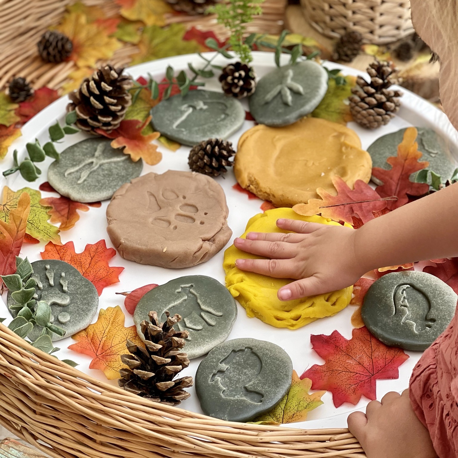 child imprinting woodland footprints into dough