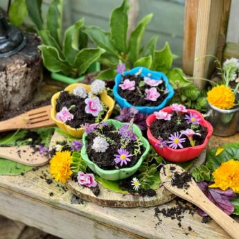flower bowls filled with mud and petals in the mud kitchen