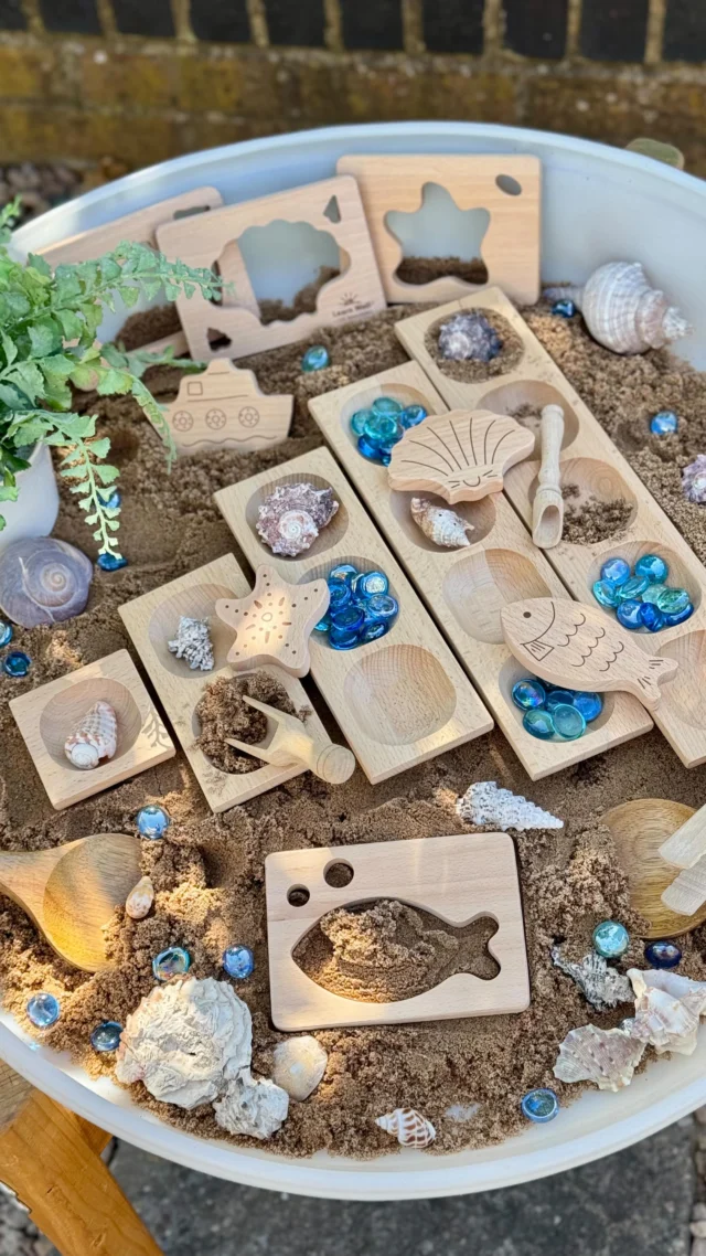 We’ve brought a little seaside magic into our maths play! Creating a sensory-rich beach-themed learning invitation.

In our sand tray, children can:
💛Scoop and pour sand into number trays, exploring how much each number holds
💛 Sort and count shells and gems into the trays – great for number bonds and 1:1 correspondence
💛 Combine trays to see how numbers fit together and form early arrays
💛 Use the Little Looking Shapes to match and fit pieces, then fill them with sand for a fun fine motor challenge

#earlyyearsmaths 
#yellowdooreducation 
#sandtrayplay 
#learningthroughplay 
#eyfsactivities 
#sensorymaths 
#handsonlearning 
#woodenresources